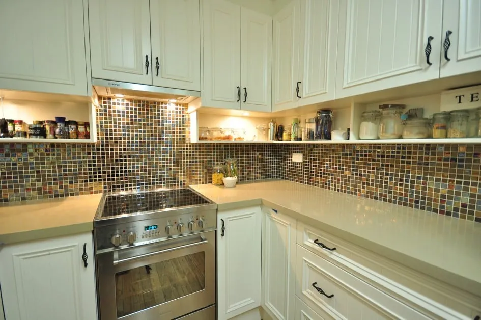 Glass mosaic tile from pooltile.ca installed on kitchen backsplash.